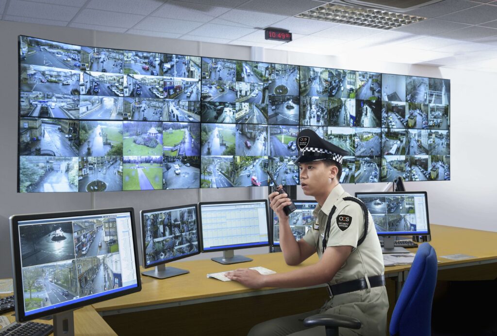 OCS security officer talking on a radio in a control room