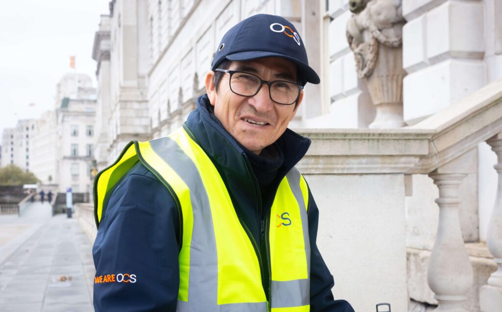 OCS colleague wearing a safety vest and a OCS branded hat