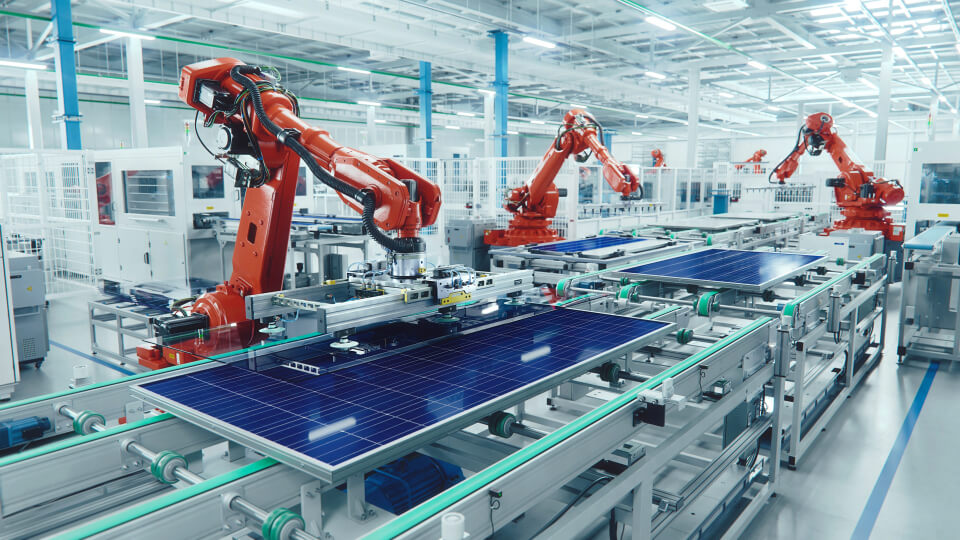 Robotic arms assemble solar panels in a modern, automated manufacturing facility.