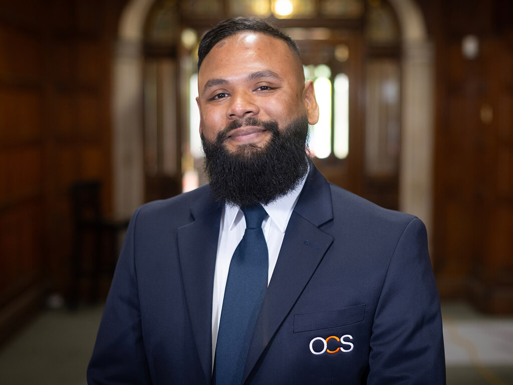 OCS Security team standing proud wearing branded jacket