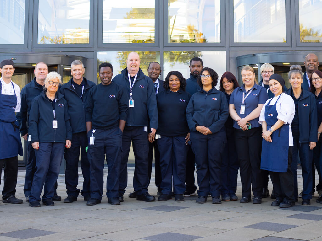 OCS team standing in front of building