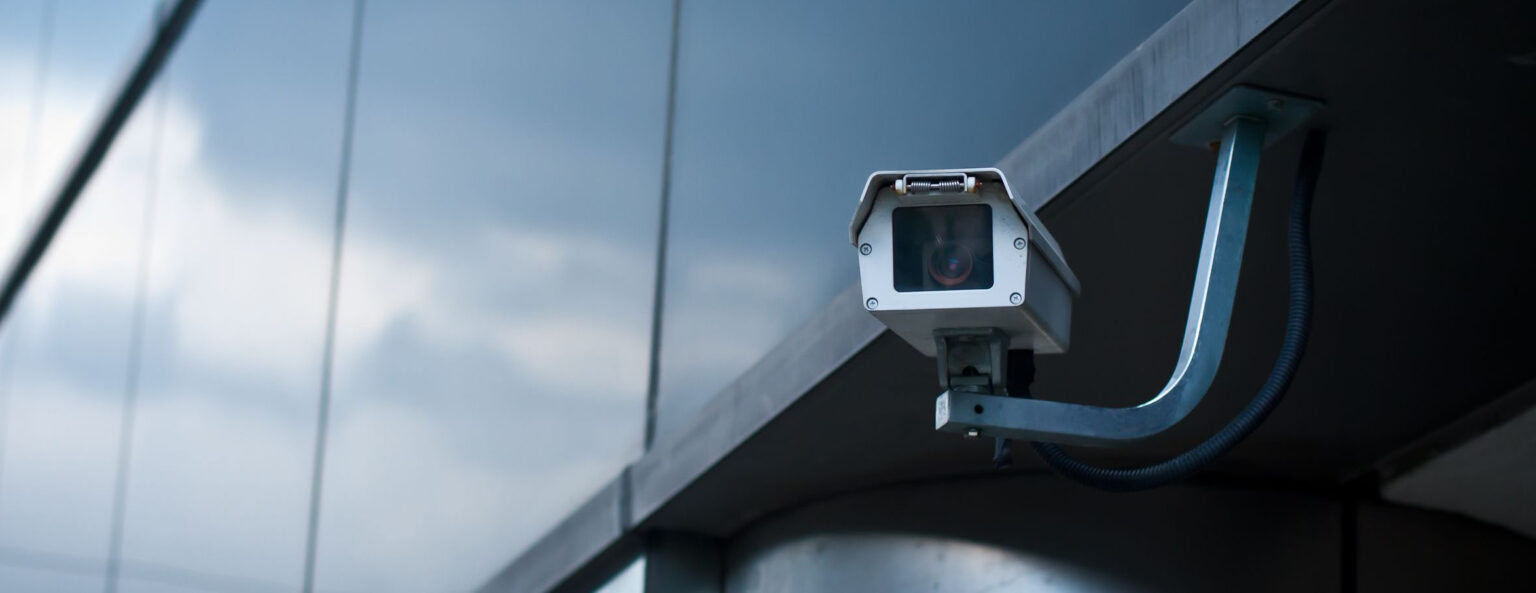 A security camera on the exterior of a building.