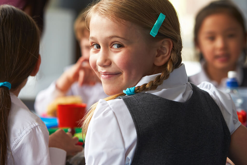 Girl Eating Healthy School Meal Provided by Thrive Catering