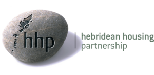 A smooth grey stone with a map of the Outer Hebrides and the letters hhp engraved on it, next to the text hebridean housing partnership in lowercase letters.