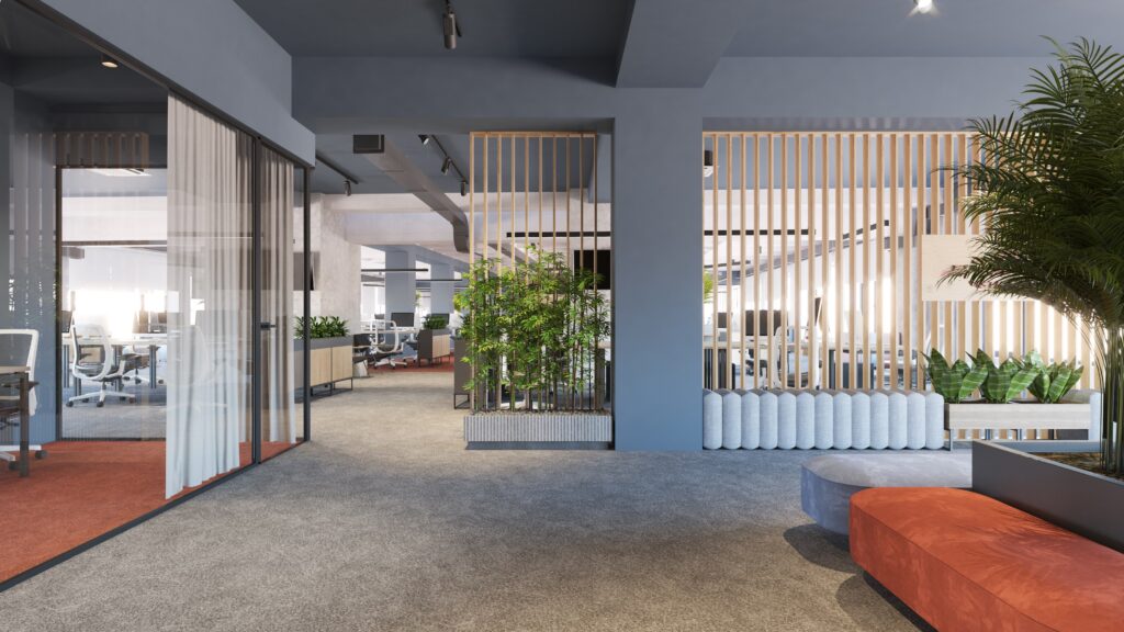 Modern open-plan office with glass-walled meeting rooms, workstations, gray carpet, potted plants, light wood partitions, and a curved orange sofa in the foreground. Natural light fills the bright, spacious area.