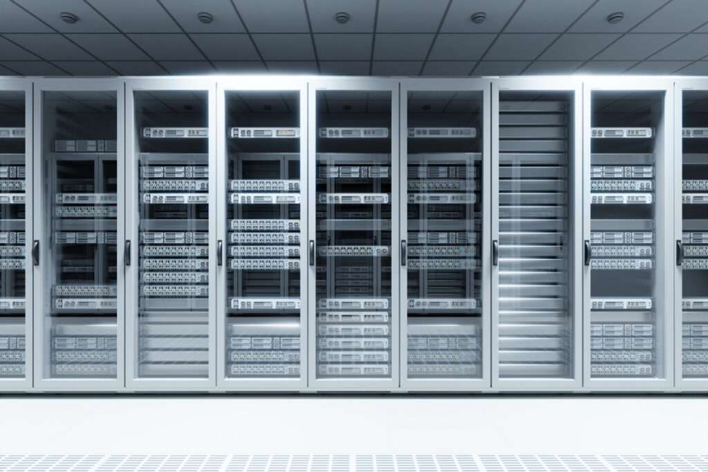A row of glass-fronted server racks in a modern data center, filled with network servers and equipment, illuminated by bright overhead lighting.