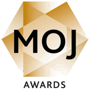 A geometric gold hexagon with MOJ in bold black letters at the center. Below the hexagon, the word AWARDS appears in uppercase black letters on a white background.