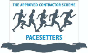 A graphic shows five silhouettes of runners in motion. Text above reads The Approved Contractor Scheme, and below, in bold blue letters, Pacesetters. A gray ribbon banner is at the bottom.