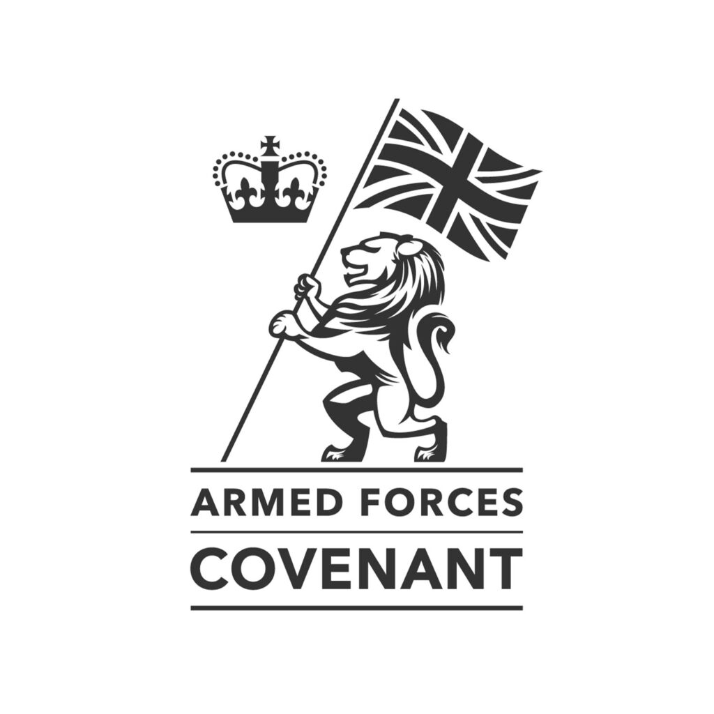 A lion holding a Union Flag stands beside a crown above the words Armed Forces Covenant in bold, black text on a white background.