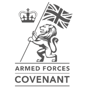 Logo with a lion holding a Union Jack flag and a crown above. Below are the words Armed Forces Covenant in bold capital letters. The design is in greyscale.