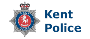 Kent Police logo featuring a crowned badge with a white horse on a red background and the words Kent Police next to it in blue text.