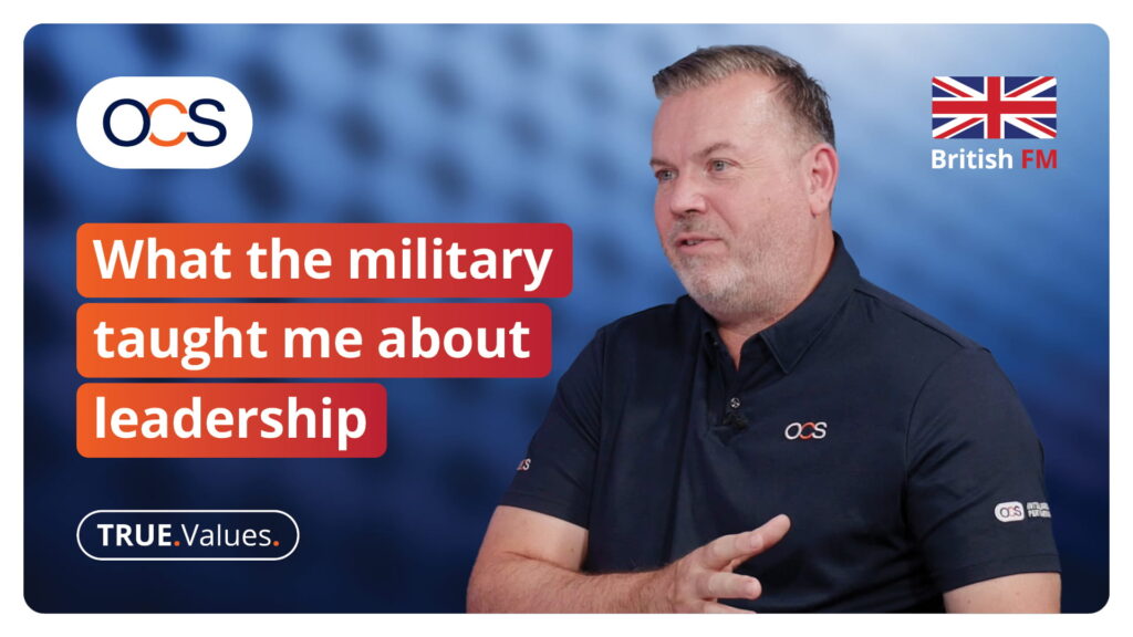 A man speaking in a video titled What the military taught me about leadership, featuring the OCS and British FM logos.