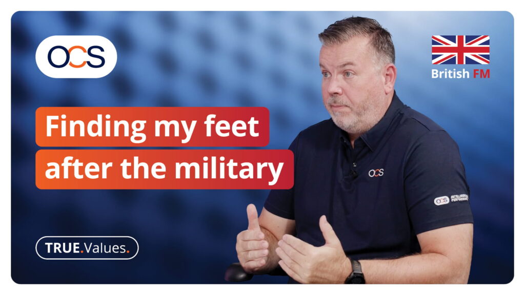 A man in an OCS polo shirt speaks during an interview titled Finding my feet after the military for British FM.